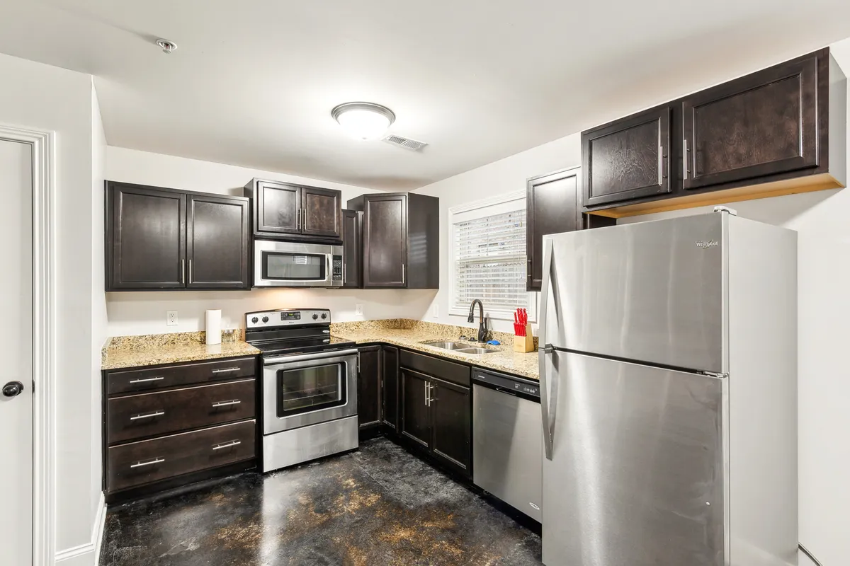 A modern kitchen with sleek cabinetry, stainless steel appliances, and polished granite countertops. The workspace is inviting, practical, and ready for both everyday meals and special gatherings, emphasizing the kitchen’s role as a culinary hub.